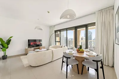a living room with a table and a couch at VayK - Modern 1BR in Downtown Dubai in Dubai