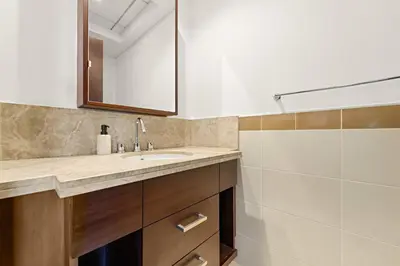 a bathroom with a sink and a shower at VayK - Modern 1BR in Downtown Dubai in Dubai