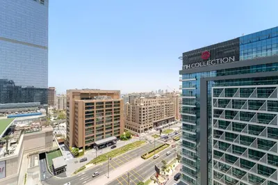 a tall building with a sign on it in a city at VayK - Modern 1BR on Palm Jumeirah in Dubai