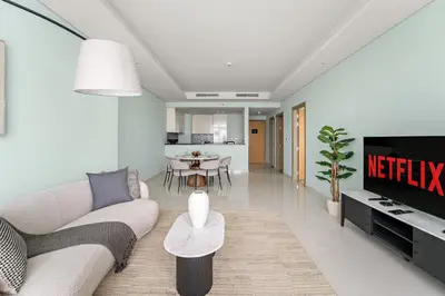 a living room with a couch and a table at VayK - Spacious 2BR Inside Hotel in Dubai