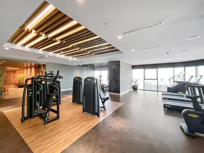 a gym with rows of exercise equipment in a room at VayK - Spacious 2BR Inside Hotel in Dubai