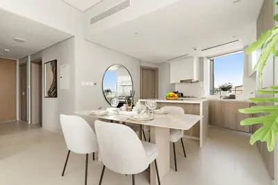 a dining room with a table and chairs and a mirror at VayK - Elegant 2BR with Luxury Amenities in LIV Marina in Dubai