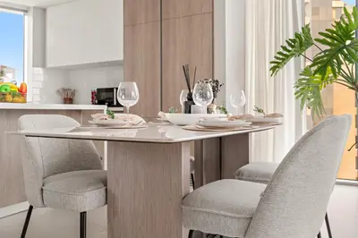a dining room table with chairs and wine glasses at VayK - Elegant 2BR with Luxury Amenities in LIV Marina in Dubai