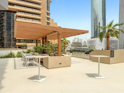 a pavilion with tables and chairs in a city at VayK - Elegant 2BR with Luxury Amenities in LIV Marina in Dubai