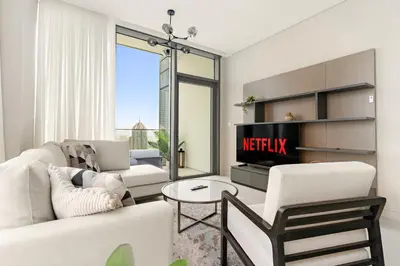 a living room with a white couch and a fireplace at VayK - Elegant 2BR with Luxury Amenities in LIV Marina in Dubai