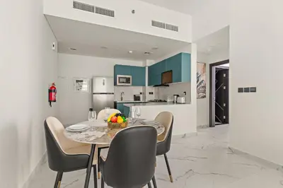 a kitchen and dining room with a table and chairs at VayK - Spacious 2BR with Private Pool in Science Park in Dubai