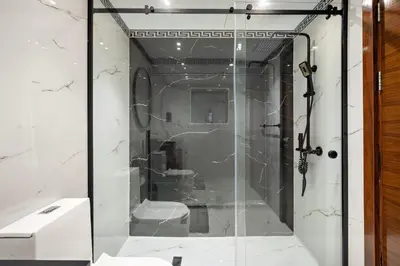 a shower with a glass door in a bathroom at VayK - Luxe 2BR with Stunning Marina Views in Dubai