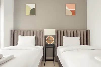 two beds sitting next to each other in a bedroom at VayK - Luxe 2BR with Stunning Marina Views in Dubai