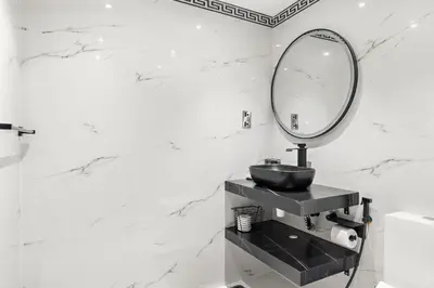 a bathroom with a sink and a mirror at VayK - Luxe 2BR with Stunning Marina Views in Dubai