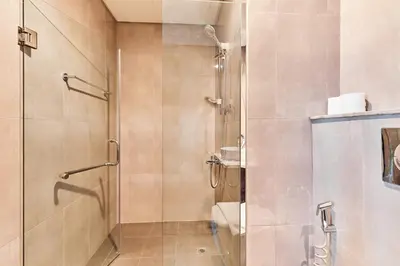 a bathroom with a shower with a glass door at Home Away 2BR in Dubai