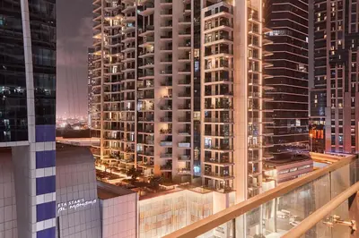 a view of a city at night with tall buildings at Home Away 2BR in Dubai