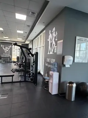 a gym with a fitness room with a treadmill at Prime location cozy apartment in Dubai