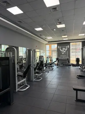 a gym with treadmills and machines in a room at Prime location cozy apartment in Dubai