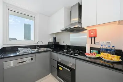 a kitchen with a sink and a stove top oven at Luxury 2BDR In Burj Khalifa View Business Bay in Dubai