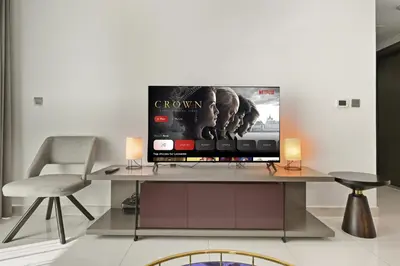 a flat screen tv sitting on top of a table at Luxury 2BDR In Burj Khalifa View Business Bay in Dubai