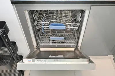 an empty dishwasher with two stools in it at Luxury 2BDR In Burj Khalifa View Business Bay in Dubai
