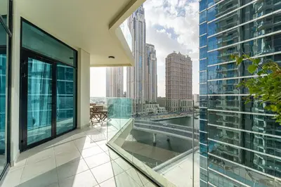 an apartment balcony with a view of a city at HAVN - 2 bedroom in Urban Oasis, Dubai Canal View in Dubai