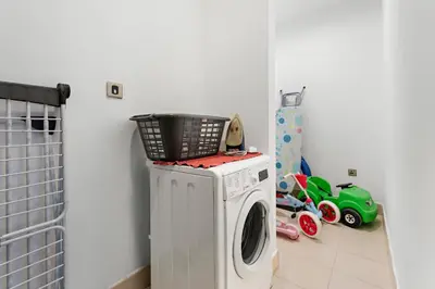 a washing machine with a basket on top of it at VayK - Spacious 2BR with Private Gym & Beach Access in Dubai