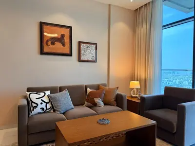 a living room with a couch and a table at Spacious 1BR- Sepcoo III Residence Al Furjan-1009 in Dubai