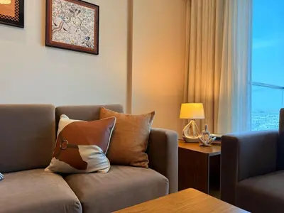 a living room with a couch and a table at Spacious 1BR- Sepcoo III Residence Al Furjan-1009 in Dubai