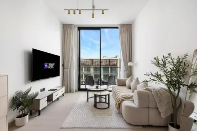 a living room with a couch and a tv at New! Cozy 1BR in Binghatti House Pool and Gym in JVC in Dubai