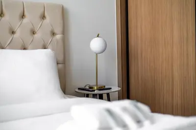 a bedroom with a bed and a lamp on a table at New! Cozy 1BR in Binghatti House Pool and Gym in JVC in Dubai