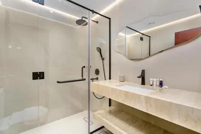 a bathroom with a shower and a sink at Vacay Lettings - Elite Residence - 1 BR - Partial Sea View in Dubai
