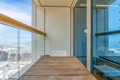 a view from the top of a building with a table and chairs at Vacay Lettings - Elite Residence - 1 BR - Partial Sea View in Dubai