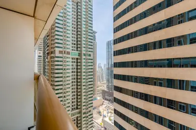 a view of a tall building from a window at Vacay Lettings - Elite Residence - 1 BR - Partial Sea View in Dubai