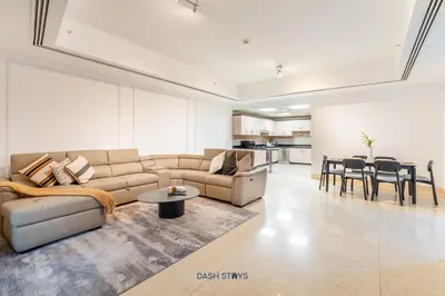 a living room with a couch and a table at Lux 2BR in Dubai Marina Walk to Beach & Metro in Dubai