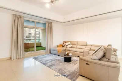 a living room with a couch and a table at Lux 2BR in Dubai Marina Walk to Beach & Metro in Dubai