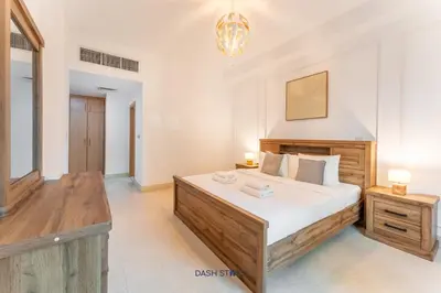 a bedroom with a large bed and a chandelier at Lux 2BR in Dubai Marina Walk to Beach & Metro in Dubai