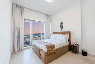 a bedroom with a large bed and a large window at Escape24 Elegant 1BR with City View near Dubai Mall in Dubai
