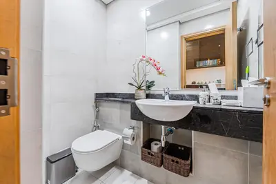 a bathroom with a white toilet and a sink at Escape24 Elegant 1BR with City View near Dubai Mall in Dubai