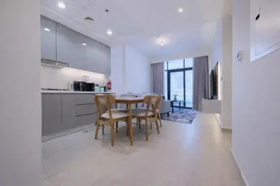 a kitchen and dining room with a table and chairs at Spacious 2BHK at Azizi Riviera 22 Meydan in Dubai