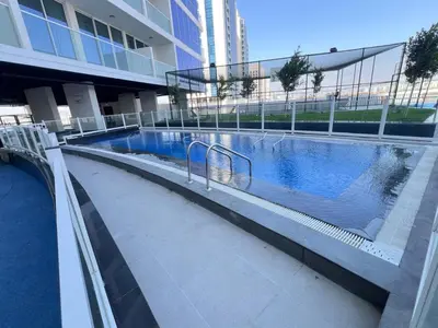 a swimming pool in the middle of a building at Blissful Retreat 1BR with 1GR Study Sleeps 4 in Gemz 05 in Dubai