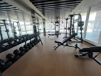 a gym with several treadmills and machines in it at Blissful Retreat 1BR with 1GR Study Sleeps 4 in Gemz 05 in Dubai