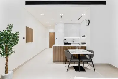 a dining room and kitchen with a table and chairs at ALiving Brand New & Modern Studio I Binghatti Galaxy, JVC- G01 in Dubai