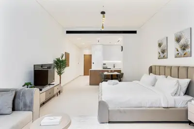 a living room with a bed and a couch at ALiving Brand New & Modern Studio I Binghatti Galaxy, JVC- G01 in Dubai