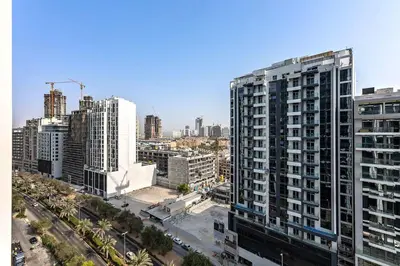 an aerial view of a city with tall buildings at Stylish 1BR Studio Unit Balcony & Pool in Dubai