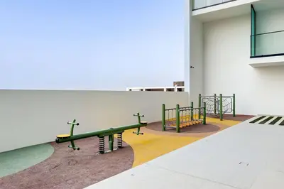 a group of benches in a room with a wall at Stylish 1BR Studio Unit Balcony & Pool in Dubai