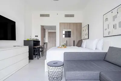 a hotel room with a bed and a couch at Frank Porter - Oxford Boulevard in Dubai