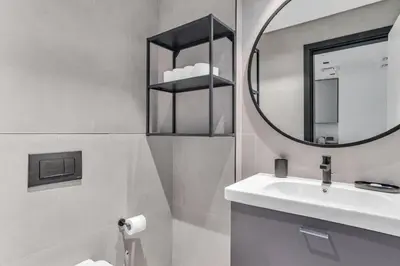a bathroom with a sink and a mirror at GuestReady - 1BR l Burj Khalifa & Canal Views in Dubai