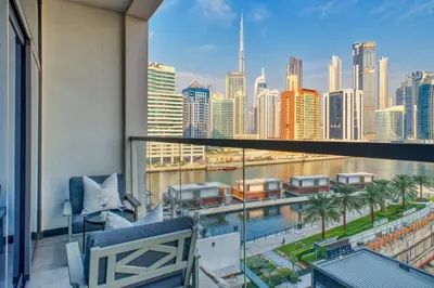 a balcony with a view of the city at GuestReady - 1BR l Burj Khalifa & Canal Views in Dubai