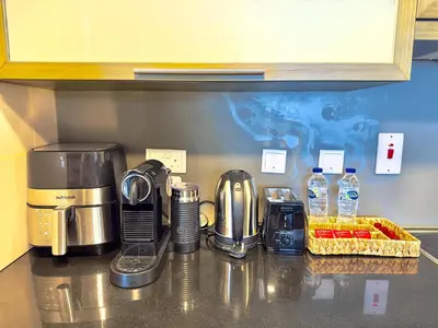 a kitchen counter with a coffee maker on a counter top at EasyGo - Elegant 1BR in Downtown Dubai in Dubai