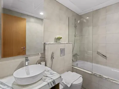 a bathroom with a sink and a toilet and a shower at Sophisticated 2BDR Living In Aykon City Business B in Dubai
