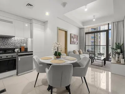 a kitchen and living room with a table and chairs at Sophisticated 2BDR Living In Aykon City Business B in Dubai