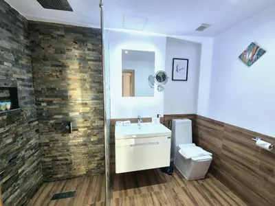 a bathroom with a sink and a toilet and a mirror at JBR l Full Sea View l 4BR l 3min to Beach l 7-12PAX in Dubai
