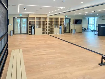 a large room with a wooden floor and shelves at New! Elegant 1BR Flat in Creek Harbour with Pool&Gym in Dubai
