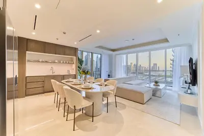 a kitchen and living room with a table and chairs at Luxury 3BR Marina View at Palace Beach Residence in Dubai